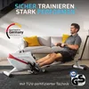 A man is using a rowing machine in a living room setting. Produktbild-Vorschau
