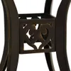 A close-up view of the decorative base of a table leg, showing intricate scrollwork. Náhled obrázku produktu