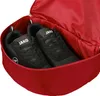 A close-up view of a red rucksack with two black athletic shoes inside. Produktbild-Vorschau