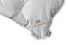 A close-up view of a white down comforter with embroidered branding and tags. Produktbild-Vorschau