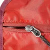 A close-up shot of a red toiletry bag with a zipper and a pull cord. Produktbild-Vorschau