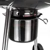 Close-up of a black kettle grill with chrome accents, showing a vent control mechanism. Produktbild-Vorschau