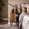 A bedroom scene with a nightstand next to a bed. Produktbild-Vorschau