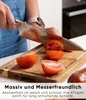 A person is slicing tomatoes on a wooden cutting board. Náhled obrázku produktu