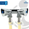 A close-up studio shot of a chrome dual outlet valve with yellow hoses attached. Produktbild-Vorschau