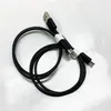 A black charging cable with multiple connectors is coiled on a white surface. Produktbild-Vorschau