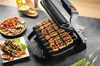 A close-up shot of a Tefal Optigrill+ Elektrogrill GC718D10 with skewers of meat and vegetables being grilled. Voir les images du produit