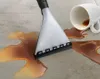 A vacuum cleaner nozzle is shown cleaning up a spill of brown liquid from a white mug on a light gray tiled floor. Náhled obrázku produktu