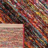 A close-up view of a colorful rug, showing both the top pile and the backing. Produktbild-Vorschau