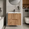 A modern bathroom with a wall-mounted vanity, sink, faucet, toilet, and bathtub. Produktbild-Vorschau