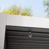 A close-up view of a metal hook attached to the underside of a gray pergola roof. Voir les images du produit