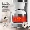 Close-up of a white coffee maker with a glass carafe showing hot coffee and steam rising. Náhľad obrázku produktu