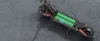 An electric scooter with its battery compartment open, showing the battery cells. Náhled obrázku produktu