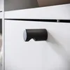A close-up shot of a drawer handle on a white cabinet. Anteprima dell’immagine prodotto