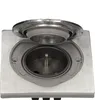 A close-up view of a hermetic socket with its lid open, showing the internal mechanism. The socket is made of stainless steel and has a gray plastic housing. Náhled obrázku produktu