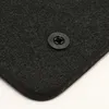 Close-up of a black car floor mat with a plastic fastener. Produktbild-Vorschau