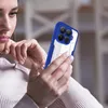 A woman is holding and looking at a smartphone with a blue case. Produktbild-Vorschau