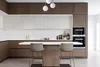 A modern kitchen with wooden cabinets, a white countertop, and two bar stools. Produktbild-Vorschau