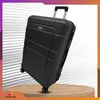 A black suitcase is displayed on a wooden stand against a striped background. Anteprima dell’immagine prodotto