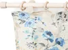 A close-up view of a floral patterned curtain hanging from a wooden curtain rod. Produktbild-Vorschau