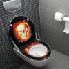 A toilet seat with a skull and flame design in a modern bathroom. Produktbild-Vorschau