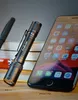 A flashlight and a smartphone are placed on a stack of books. Náhled obrázku produktu
