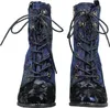 A pair of blue floral patterned ankle boots with black toe caps and soles, shown from the front. Produktbild-Vorschau