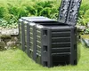 A black compost bin is shown in a garden setting with green foliage in the background. Náhled obrázku produktu