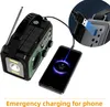 A portable emergency radio is shown charging a smartphone. The radio has solar panels and a flashlight. The text "Emergency charging for phone" is visible at the bottom. Podgląd zdjęcia produktu