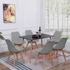 A dining room set with a black table and six gray chairs, set against a backdrop of a large window and a framed picture on the wall. Voir les images du produit