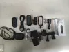 A collection of action camera accessories laid out on a light gray surface. Podgląd zdjęcia produktu
