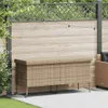 A beige poly rattan garden storage box with wheels is placed on a patio in front of a wooden fence with string lights. Náhled obrázku produktu