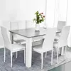 A dining table and chairs set with a vase of flowers on the table. Voir les images du produit