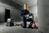 A construction worker is using a Metabo Allessauger ASR 35 M ACP vacuum cleaner with a rotary hammer in a concrete room. Náhľad obrázku produktu