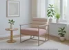 A lounge chair in a well-lit room with plants and a side table. Voir les images du produit