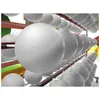 Rows of white, textured balls are displayed on metal racks. Produktbild-Vorschau