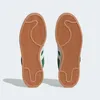The image shows the bottom view of two green Adidas Campus 00s sneakers against a white background. Podgląd zdjęcia produktu