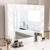A white vanity mirror with LED lights and makeup products on a white vanity table. Podgląd zdjęcia produktu