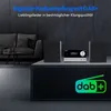 A modern living room setting with a micro audio system and speakers on a stand, with a sofa in the background. Produktbild-Vorschau