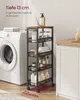 A narrow rolling shelf unit filled with toiletries and towels is placed next to a washing machine in a laundry room or bathroom setting. Produktbild-Vorschau