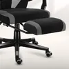 A close-up view of the base and footrest of a black and gray gaming chair. Náhled obrázku produktu