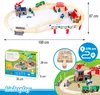 A wooden train set with various accessories, including buildings, trains, and vehicles, displayed in a promotional layout with dimensions and a close-up of the track. Náhled obrázku produktu