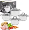 A set of stainless steel pots with glass lids, alongside raw ingredients like chicken, potatoes, carrots, and lettuce, suggesting a cooking context. A product box is also visible. Produktbild-Vorschau