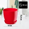 A red plastic plant pot with a saucer, shown on a white surface with a blurred background. Anteprima dell’immagine prodotto