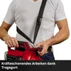 A person wearing a white t-shirt is holding a red leaf blower with a black strap over their shoulder. Produktbild-Vorschau