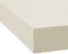 A close-up, angled view of a cream-colored fitted sheet.