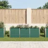 A row of green raised garden beds with plants in them, set against a wooden fence and a light-colored wall. Náhľad obrázku produktu