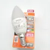 A white LED light bulb with a silver base is shown in front of its orange and white packaging. Náhled obrázku produktu