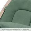 Close-up of a green fabric cushion with a wooden frame and a label. Produktbild-Vorschau