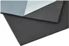 A close-up, angled view of a layered material, likely insulation or soundproofing, with a black foam layer in the foreground and a gray textured layer and white backing visible behind it. Produktbild-Vorschau